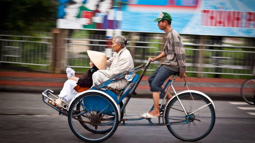 getting around in ho chi minh city food bike saigon by night after dark tour saigonkisstours.com cyclo grab uber transportation bus