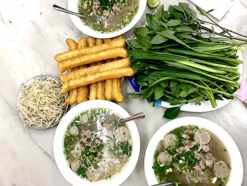 table with authentic pho noodle soup in ho chi minh 